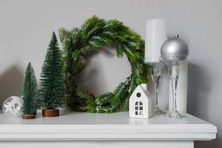 Mantelpiece with Christmas decorations near white wall, closeupの写真素材