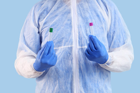Mature scientist with test tubes on blue background, closeupの写真素材