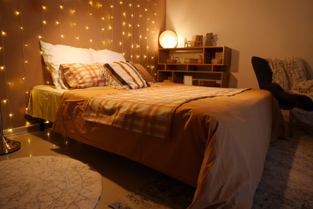 Interior of bedroom with glowing lights and lamp at night