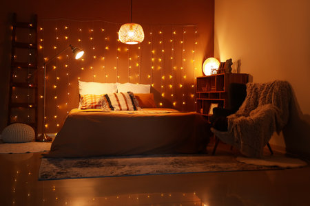Interior of bedroom with glowing lights and lamps at nightの写真素材