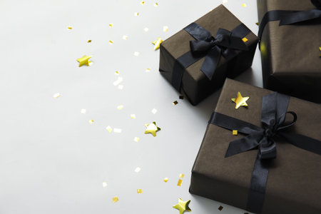 Gift boxes with confetti on white backgroundの写真素材