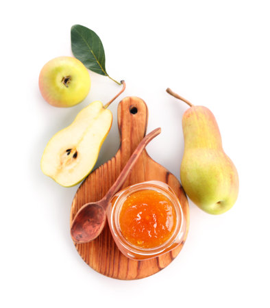 Wooden board with glass jar of tasty pear jam on white backgroundの写真素材
