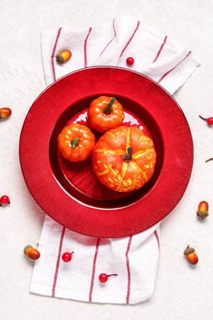 Stylish autumn table setting with pumpkins, acorns and viburnum on white backgroundの写真素材