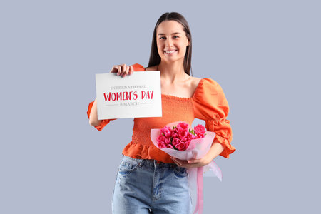 Young woman with bouquet of tulips and greeting card on light background. International Women's Dayの写真素材