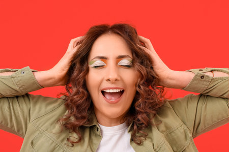 Happy woman with Irish makeup on red background. St. Patrick's Day celebrationの写真素材