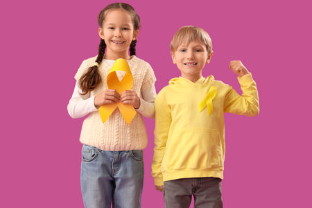 Cute little children with yellow ribbons on purple background. Childhood cancer awareness conceptの写真素材