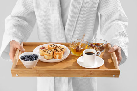 Young man with tasty breakfast on light background, closeup. Valentine's Day celebrationの写真素材