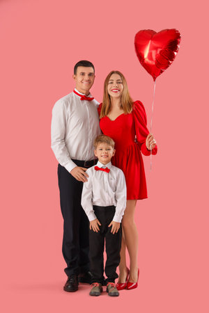 Little boy with his parents and heart-shaped balloon on pink background. Valentine's Day celebrationの写真素材