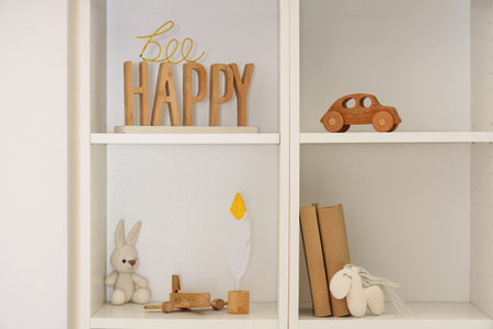 Shelf unit with books, toys and decor in children's roomの写真素材