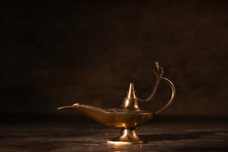 Aladdin lamp of wishes for Ramadan on dark wooden backgroundの写真素材