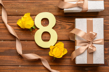 Figure 8 with gift boxes, ribbon and beautiful yellow roses on wooden background. International Women's Dayの写真素材