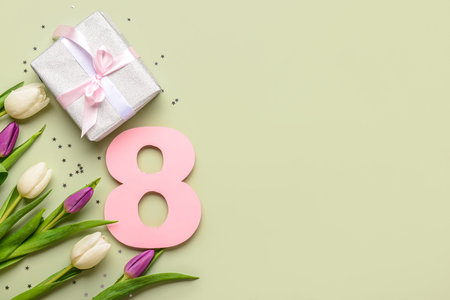Figure 8 with gift box and beautiful tulips on green background. International Women's Day
