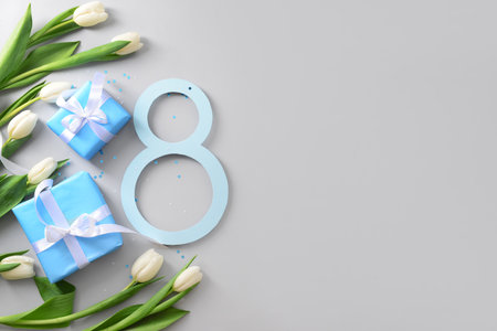 Figure 8 with gift boxes and beautiful tulips on gray background. International Women's Dayの写真素材
