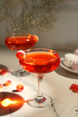 Glass of tasty cocktail with marmalade on light table, closeup. Valentine's Day celebrationの写真素材