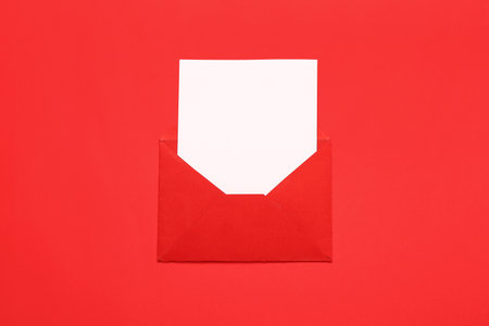 Composition with envelope and card on red background. Valentine's Day celebrationの写真素材