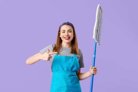 Pretty woman pointing at mop on purple background