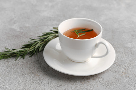 Cup of hot rosemary tea on gray backgroundの写真素材