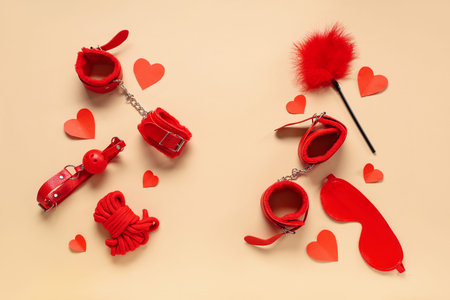 Composition with different sex toys and paper hearts on color background. Valentine's Day celebrationの写真素材