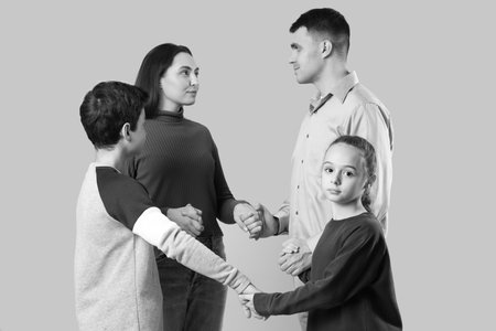 Family praying together on light backgroundの写真素材