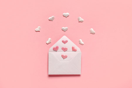 Composition with envelope and hearts on pink background. Valentine's Day celebrationの写真素材