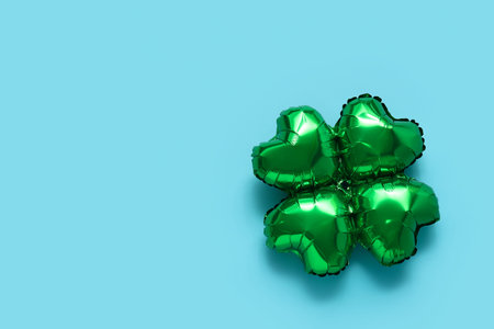 Balloon in shape of clover on blue background. St. Patrick's Day celebration