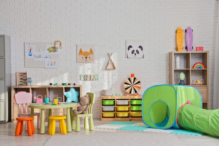 Interior of playroom with shelves and toys in kindergartenの写真素材