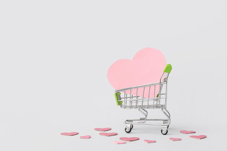 Small shopping card with paper hearts on white background. Valentine's Day celebrationの写真素材