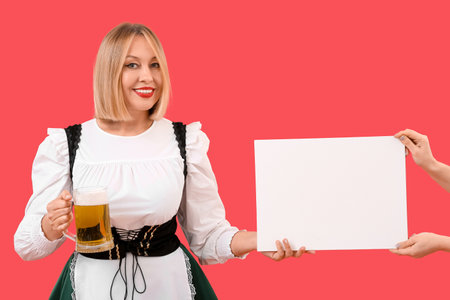 Happy woman drinking beer and hands with blank poster on red background. St. Patrick's Day celebrationの写真素材