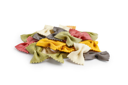 Colorful uncooked farfalle pasta on white backgroundの写真素材