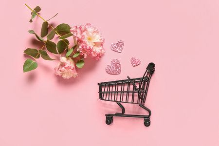 Small shopping card with paper hearts and flowers on pink background. Valentine's Day celebrationの写真素材