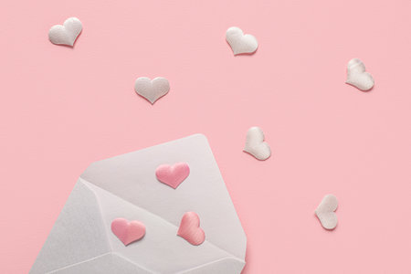 Composition with envelope and hearts on pink background. Valentine's Day celebrationの写真素材