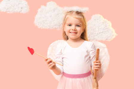 Cute little girl dressed as cupid with bow, arrow and clouds on pink background. Valentine's Day celebrationの写真素材
