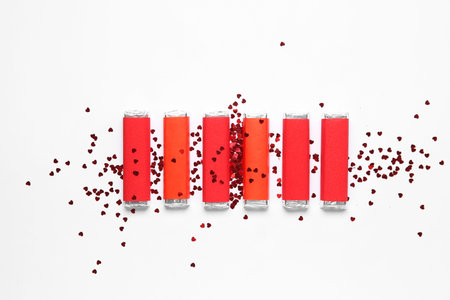 Many tasty chocolate bars with heart-shaped confetti on white background. Valentine's Day...