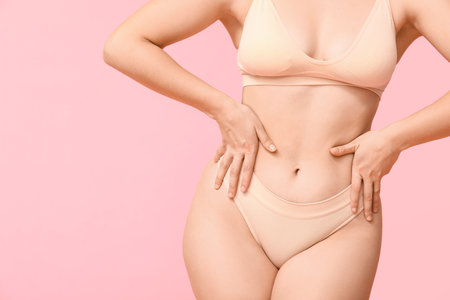 Body positive woman in underwear on pink background, closeupの写真素材