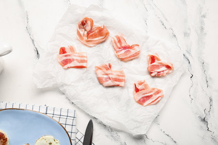 Paper with hearts made of tasty bacon on light backgroundの写真素材