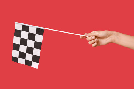 Woman with racing flag on red background