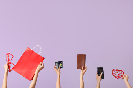Women with shopping bag, credit cards, wallet, payment terminal and decor on lilac background. Valentine's Day celebrationの写真素材