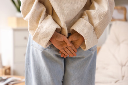 Mature woman with hemorrhoids at home, back viewの写真素材