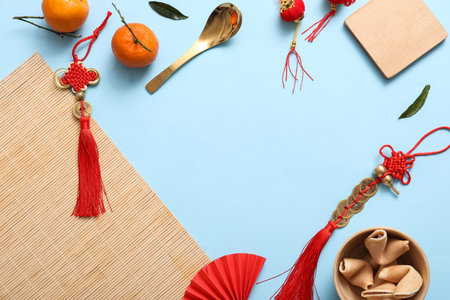 Frame made from tangerines, fortune cookies and Chinese symbols on blue background. New Year celebrationの写真素材