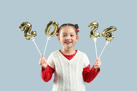 Cute little Asian girl with figure 2024 on gray background. Chinese New Year celebration