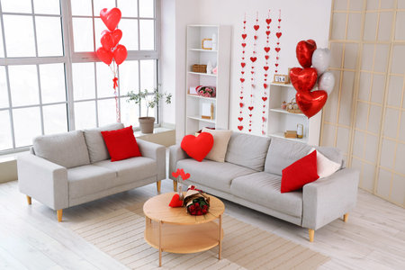 Interior of living room decorated for Valentine's Day with sofas, hearts and balloons
