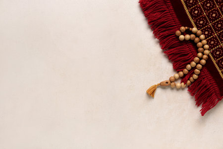 Prayer mat and beads for Ramadan on white grunge backgroundの写真素材