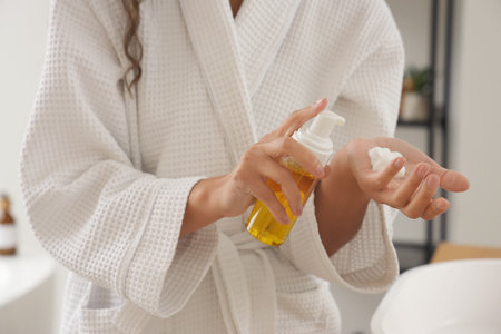 Young woman with cleansing foam in bathroom, closeupの写真素材