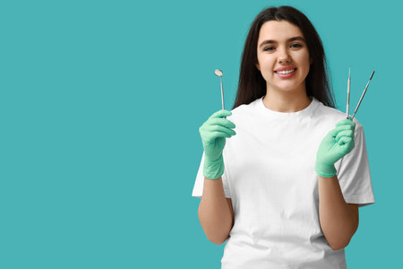 Female dentist with tools on blue background. World Dentist Dayの写真素材
