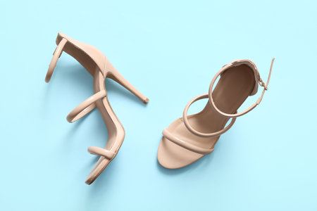 Pair of stylish high-heeled shoes on color backgroundの写真素材