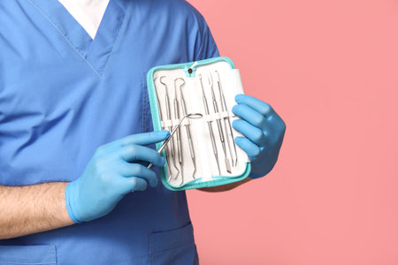 Dentist with set of dental tools on pink background. World Dentist Dayの写真素材