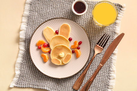 Funny Easter bunny pancakes mandarin and berries on beige backgroundの写真素材