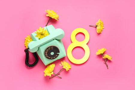 Figure 8 made of paper with retro telephone and beautiful yellow chrysanthemum flowers on pink...