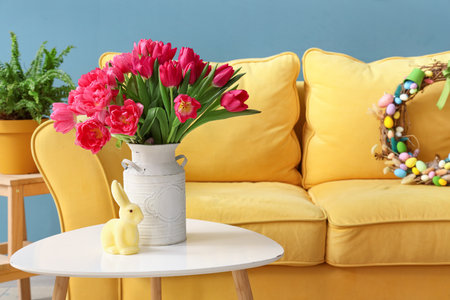 Vase with tulips and Easter rabbit on table in living roomの写真素材
