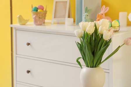 Vase with tulips in room, closeup. Easter celebrationの写真素材